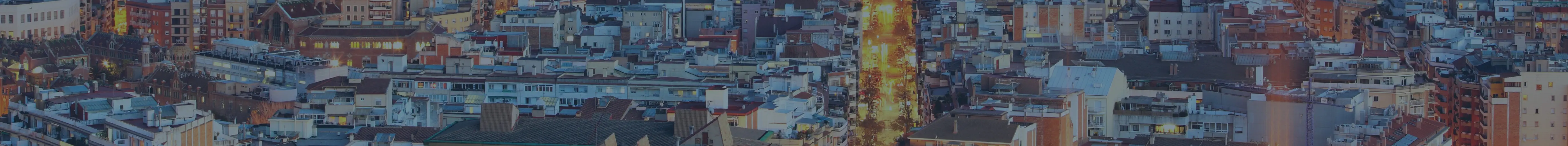 An aerial view of a city at night providing legal advice for property buying in Spain.