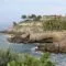 A property in Tenerife with a rocky cliff near the ocean.