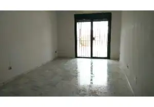 An empty apartment with a sliding glass door in Malaga-FUENGIROLA.