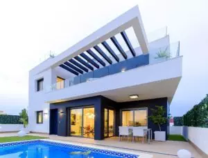 A modern villa for sale in Villamartín - Orihuela Costa, featuring a swimming pool and patio.