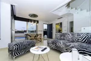 Villa for sale in Villamartín - Orihuela Costa with zebra print furniture in the living room.