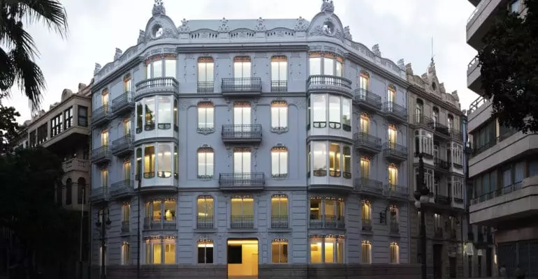 An architect renovation in Spain transformed a white building on the corner of a street.