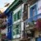Set up your bed and breakfast in Spain and experience the vibrant life of a B&B manager surrounded by a colorful row of buildings adorned with balconies and flower pots.
