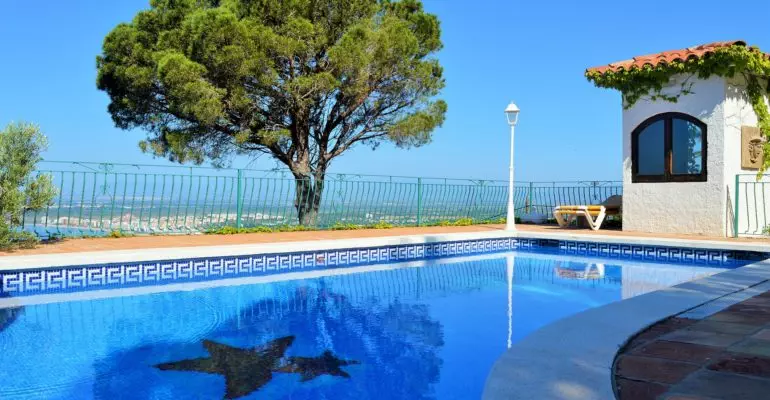 A Spanish B&B with a blue swimming pool.