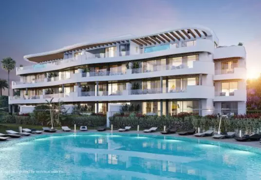 A newly built apartment complex with a swimming pool and lounge chairs, available for sale in Fuengirola or Malaga.