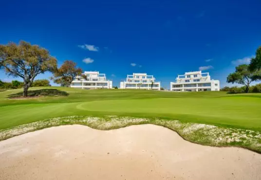 A golf course featuring a sand bunker.