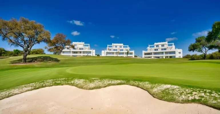 A golf course featuring a sand bunker.