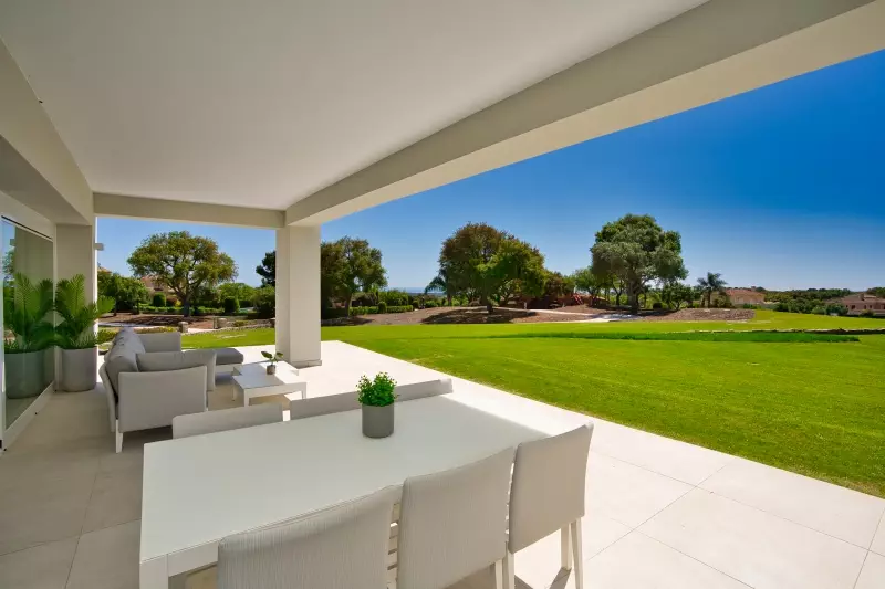 A new build penthouse with a patio overlooking a golf course.