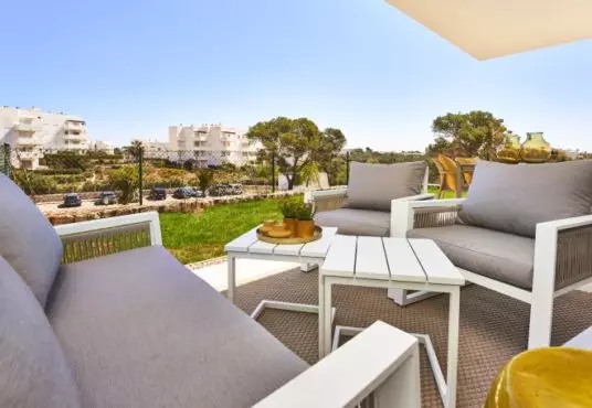 A new build apartment in Cala d'Or with a balcony and a view of the city.