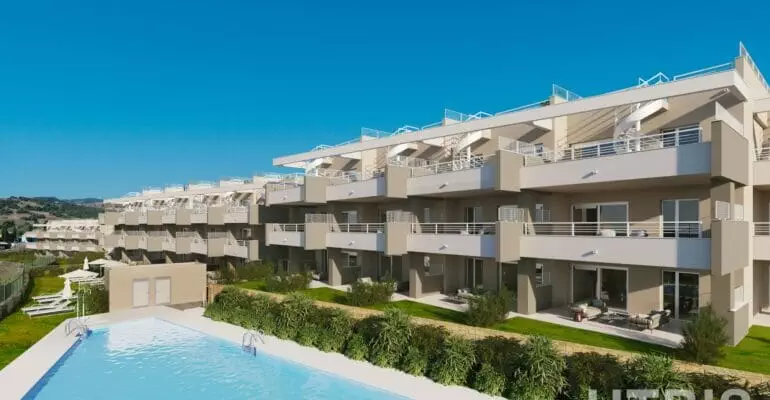 An apartment complex with a swimming pool near Estepona Golf Course.