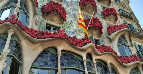 The Unesco World Heritage site in Spain is surrounded by a vibrant display of red flowers.