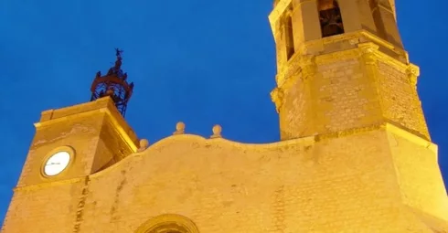 A Sitges real estate property featuring a charming brick building with a clock tower.