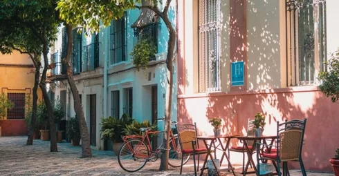 A table and chairs on a cobblestone street in Spain.