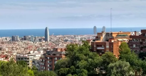 A view of the city of Barcelona from the top of a hill.