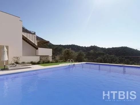 An apartment in Malaga with a swimming pool and a view of the mountains.