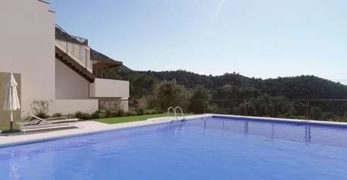 An apartment in Malaga with a swimming pool and a view of the mountains.