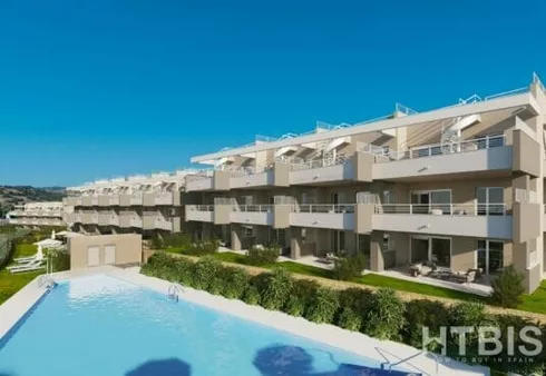 An apartment complex with a swimming pool near Estepona Golf Course.